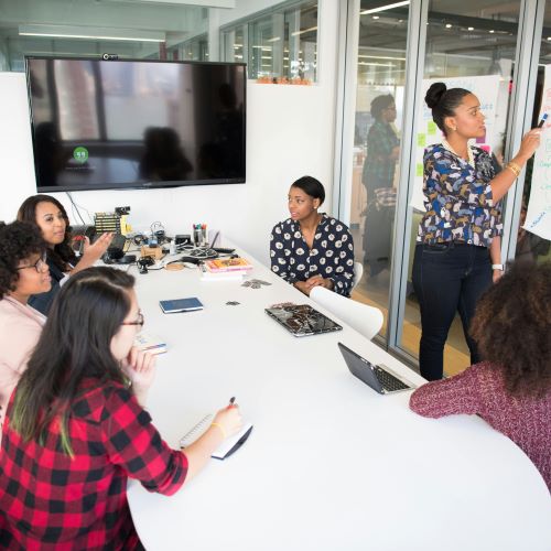 A group of women working together in a meeting room